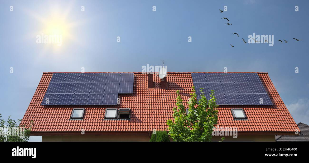 Renewable green energy solar panels on house roof Stock Photo - Alamy