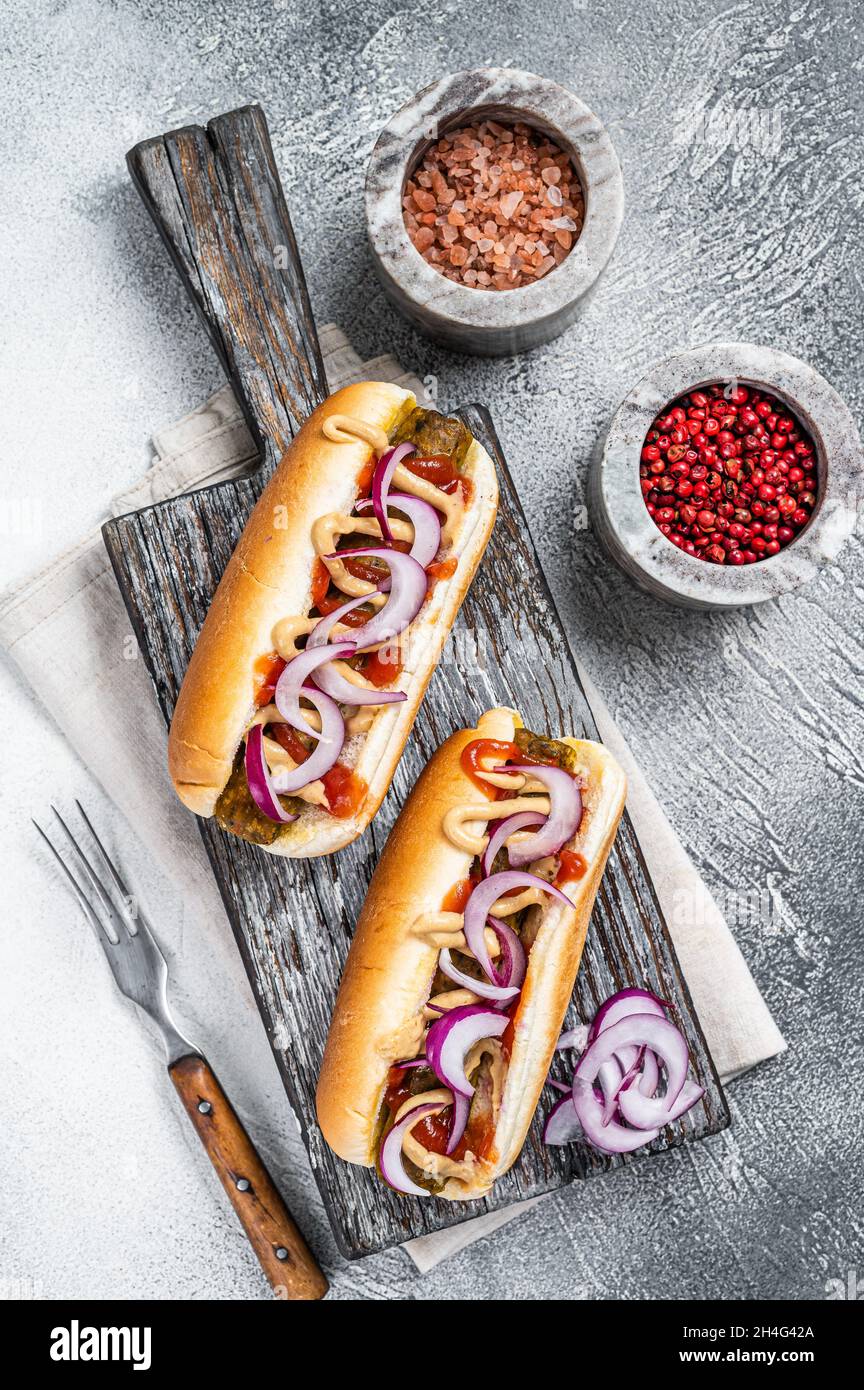 Vegetarian hot dog with with toppings and meatless sausage. White