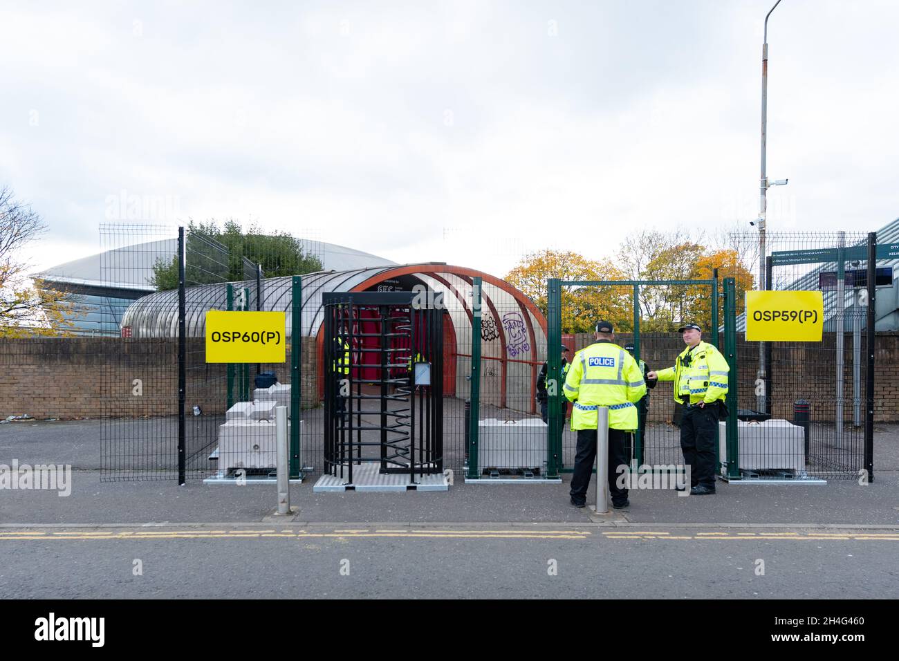 Security fencing and police outside the 'smartie tube' covered tunnel walkway over Clydeside Express leading to the SEC during COP26, Glasgow Scotland Stock Photo