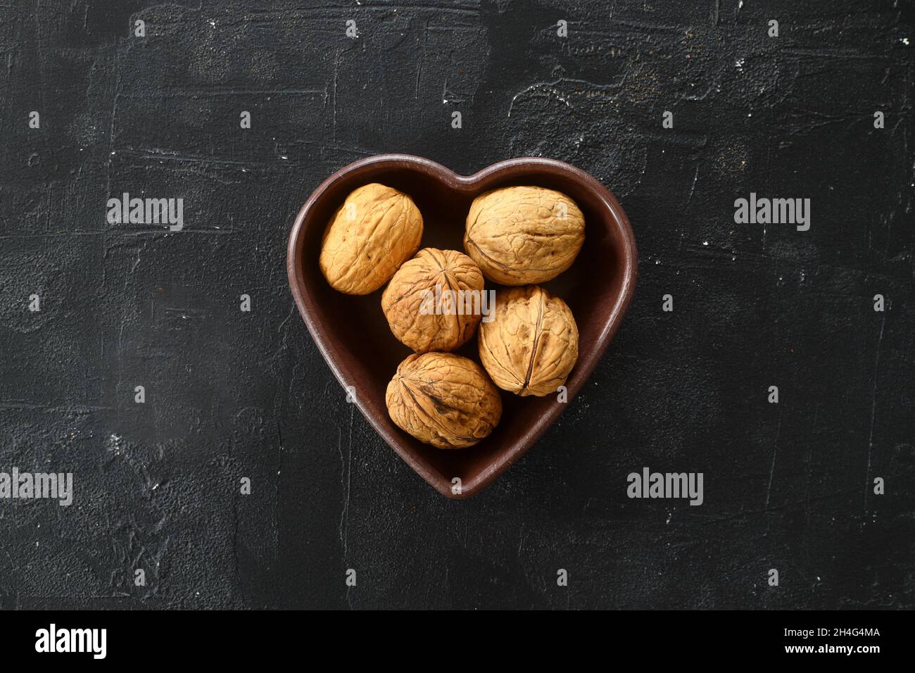 Inshell walnuts in a heartshaped plate. Heart Nuts, Heart Health
