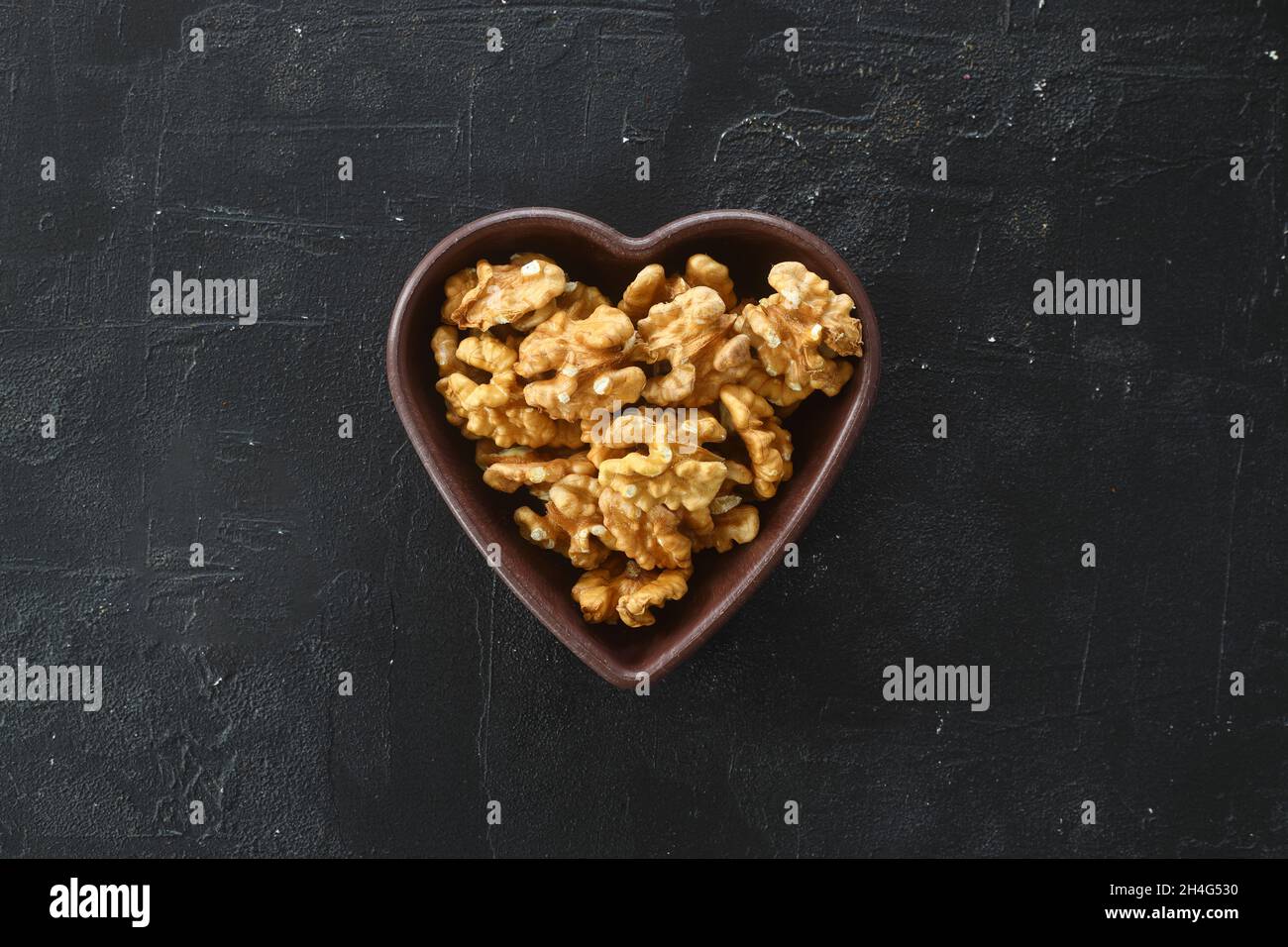 Inshell walnuts in a heartshaped plate. Heart Nuts, Heart Health