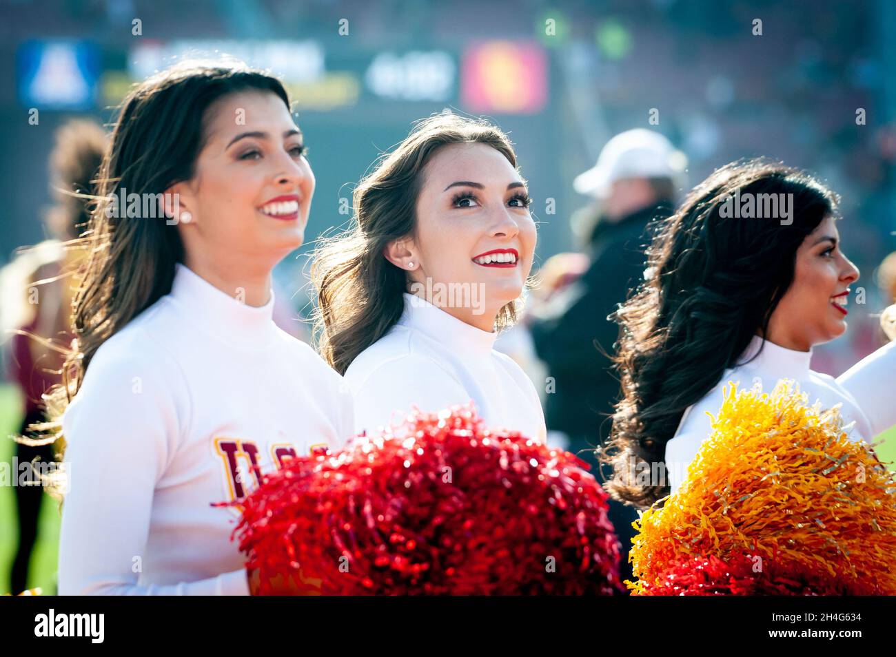 USC cheerleaders are all smiles on the sidelines during an NCAA college football game against the Arizona Wildcats. The Trojans defeated the Wildcats Stock Photo