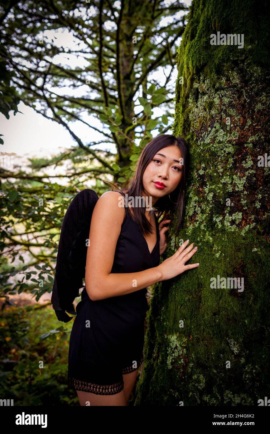 Young Woman Wearing a Grim Reaper Cosplay Outfit in the Woods Stock Photo