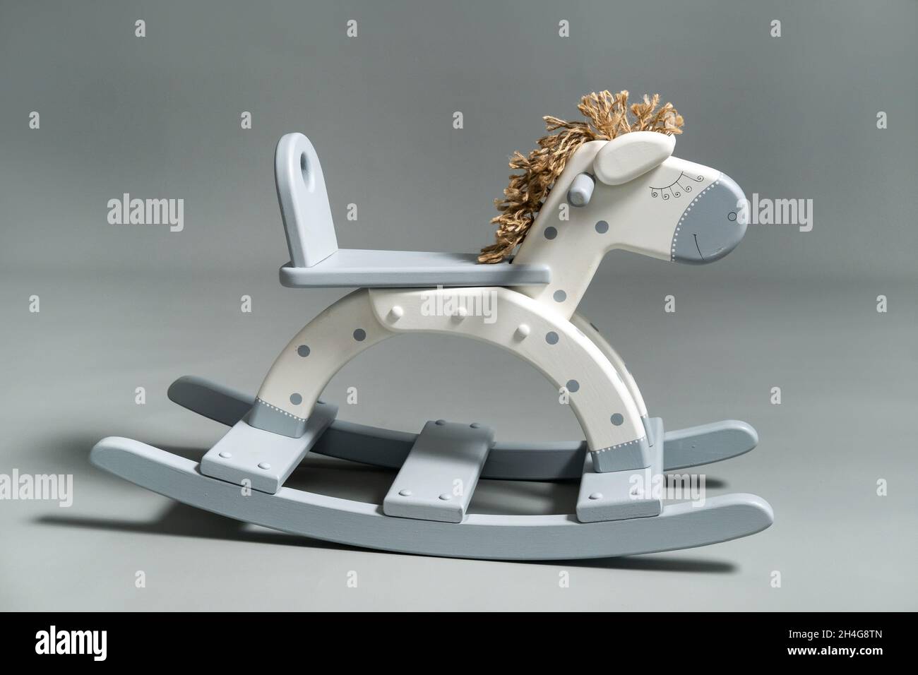 Handmade rocking horse on a gray background Stock Photo - Alamy