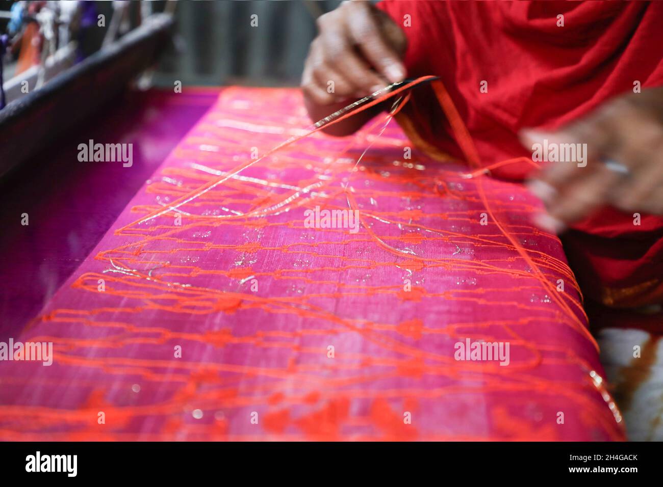 Dhaka, Bangladesh. 02nd Nov, 2021. A women seen making Jamdani saree at Demra Jamdani Palli. Jamdani is one of the finest muslin textiels of Bengal, produced in Dhaka District, Bangladesh for centuries. The Historic production of jamdani was patronized by imperial warrants of the Mughal emperors. Under British colonialism, the Bengali Jamdani and muslin industries rapidly declined due to colonial import policies favoring industrially manufactured textiles. Credit: SOPA Images Limited/Alamy Live News Stock Photo