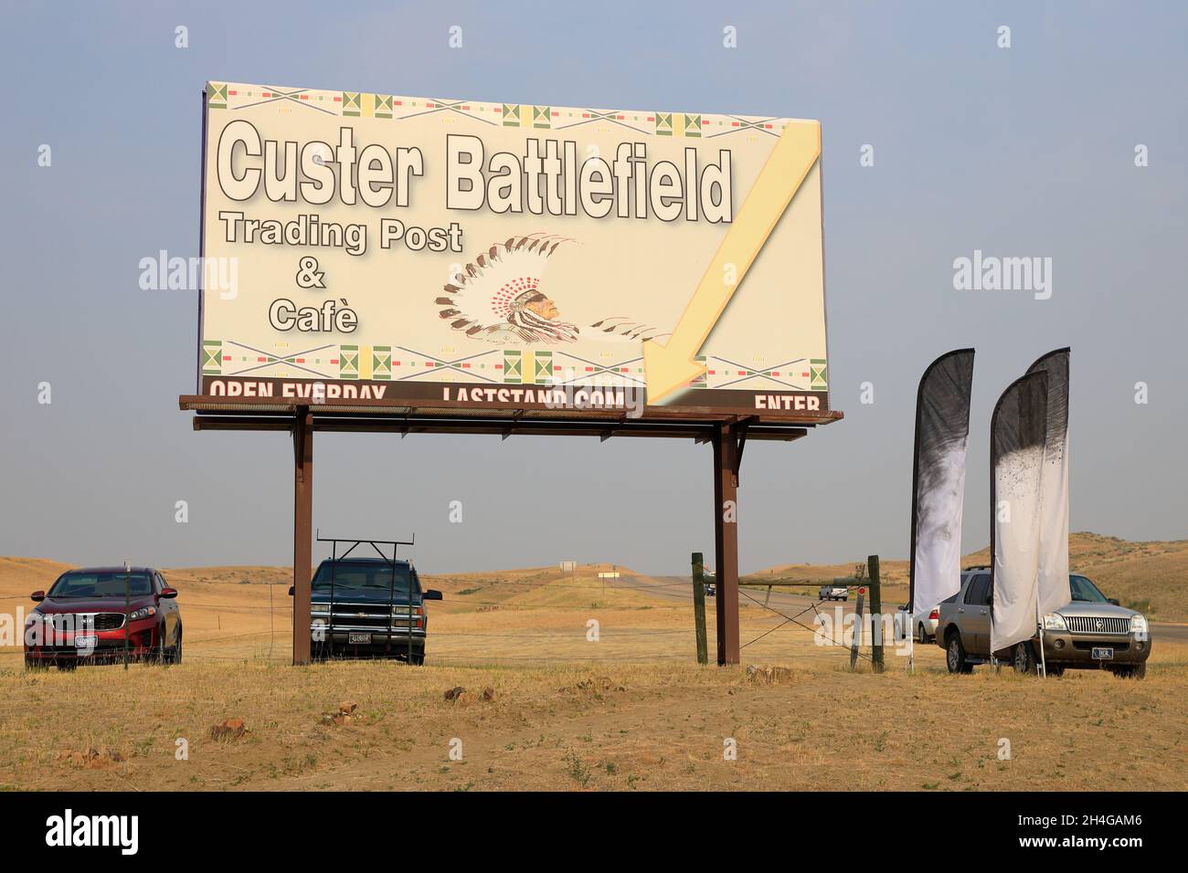 The sign of Custer Battlefield Trading Post & Cafe with vehicles park underneath.Crow Agency.Montana.USA Stock Photo