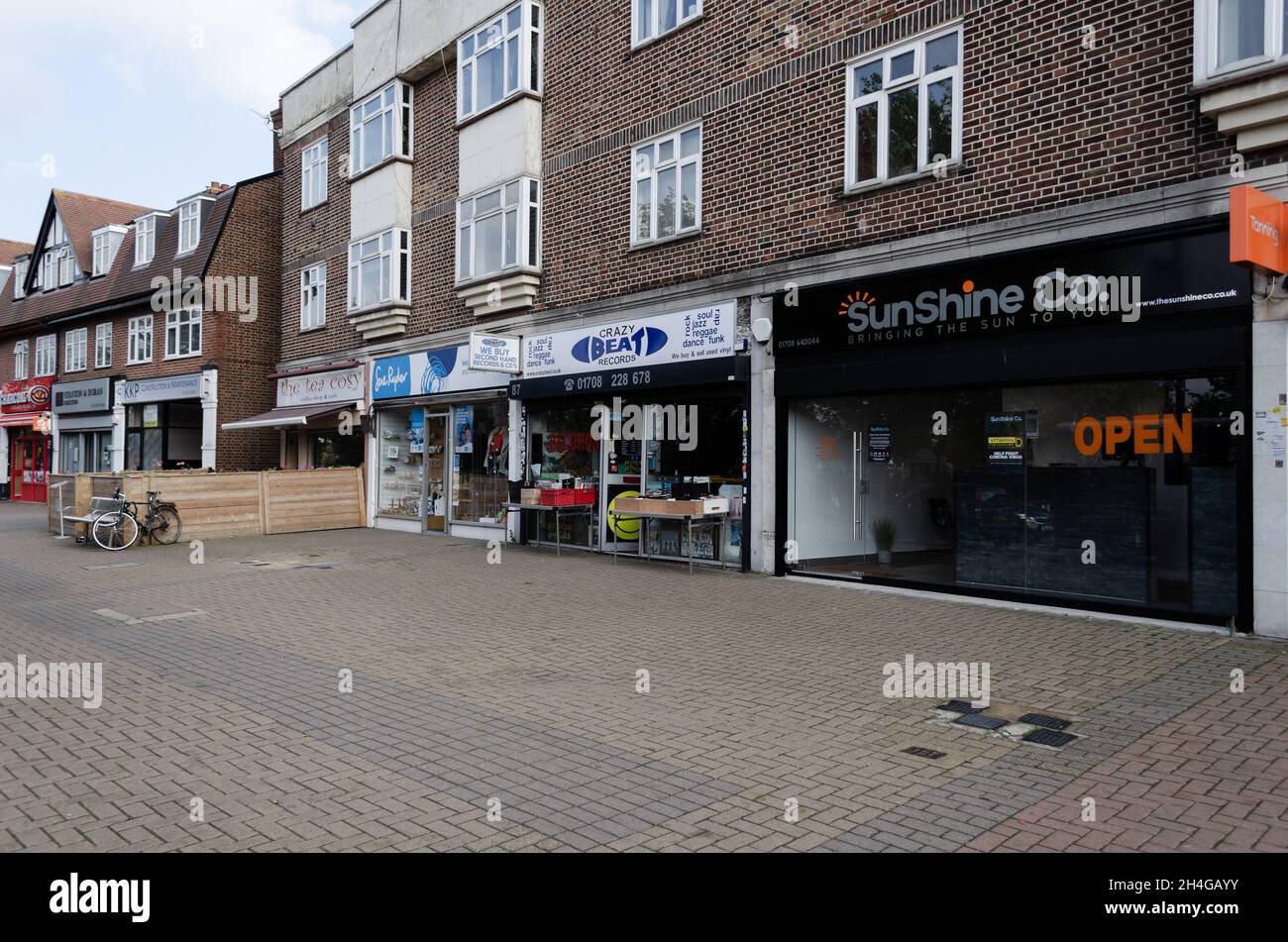 High street shops with apartments above, along Corbets Tey Road in
