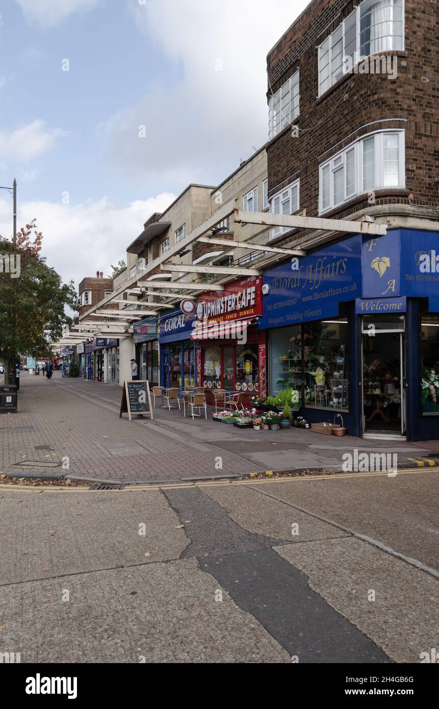 High street shops with apartments above, along Corbets Tey Road in