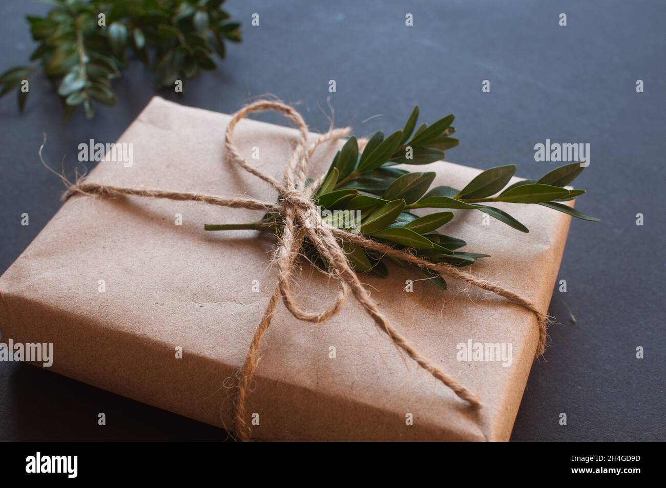 Gift box wrapped in craft paper with dried flowers Stock Photo - Alamy