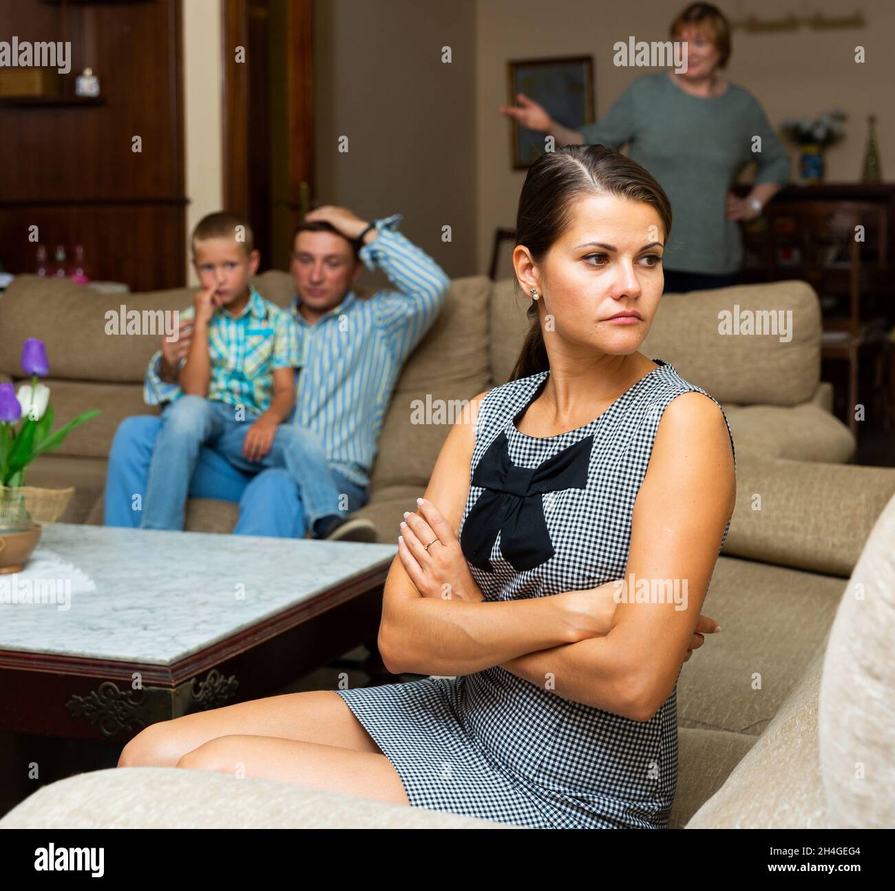 Offended woman after quarrel with mother and husband Stock Photo