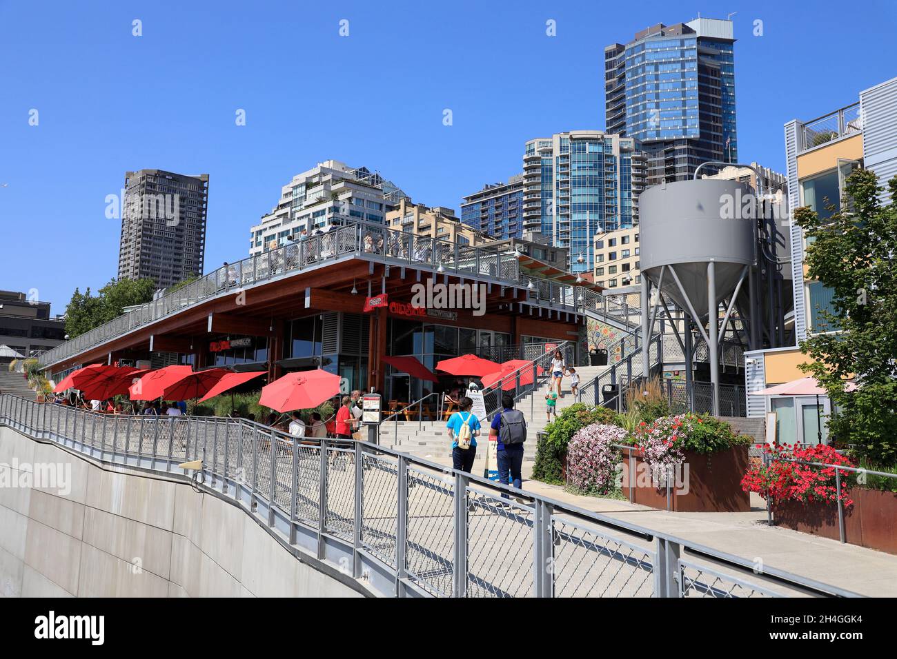 Visitors on the terrace of Pike Place Market above Old Stove Brewing with  office and apartment buildings in the background.Seattle.Washington.USA Stock Photo