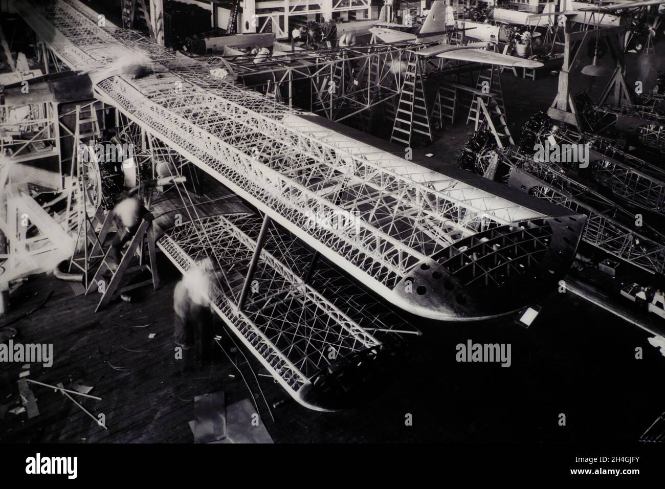 Historical black and white photography showing airplane making in ...