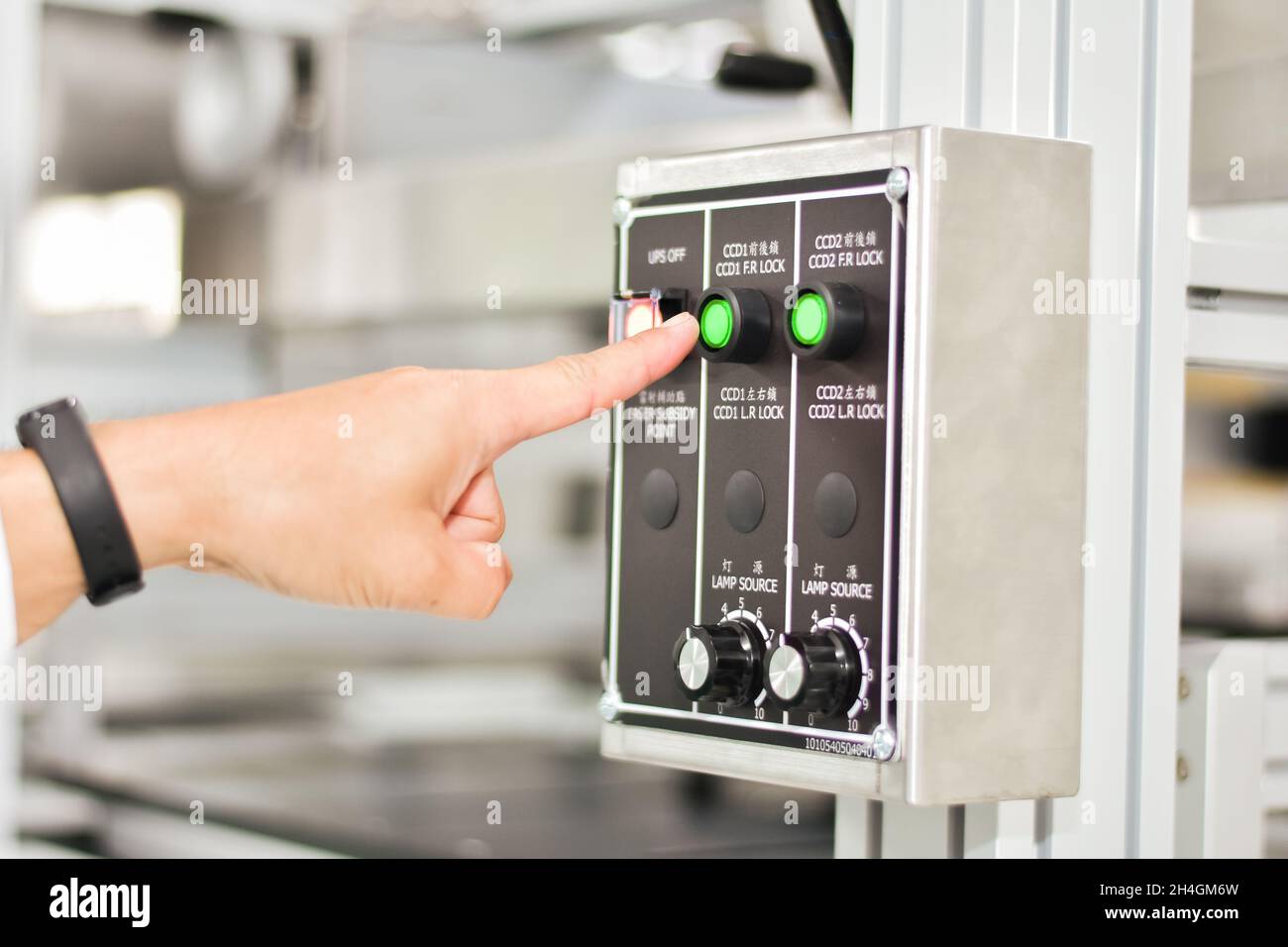 Hand touch on emergency stop machine Stock Photo
