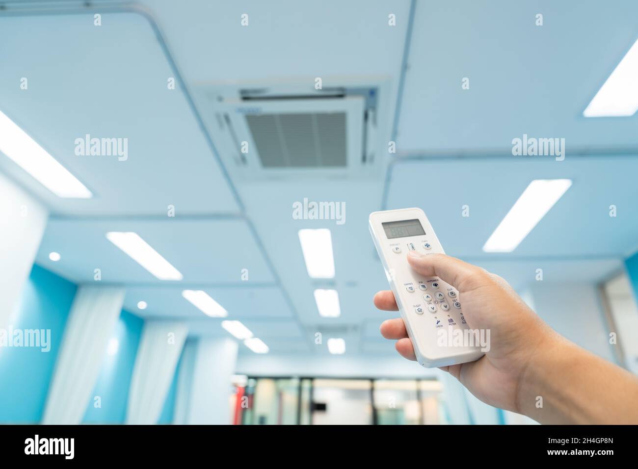 hand holding built-in large air conditioner remote control in the ...