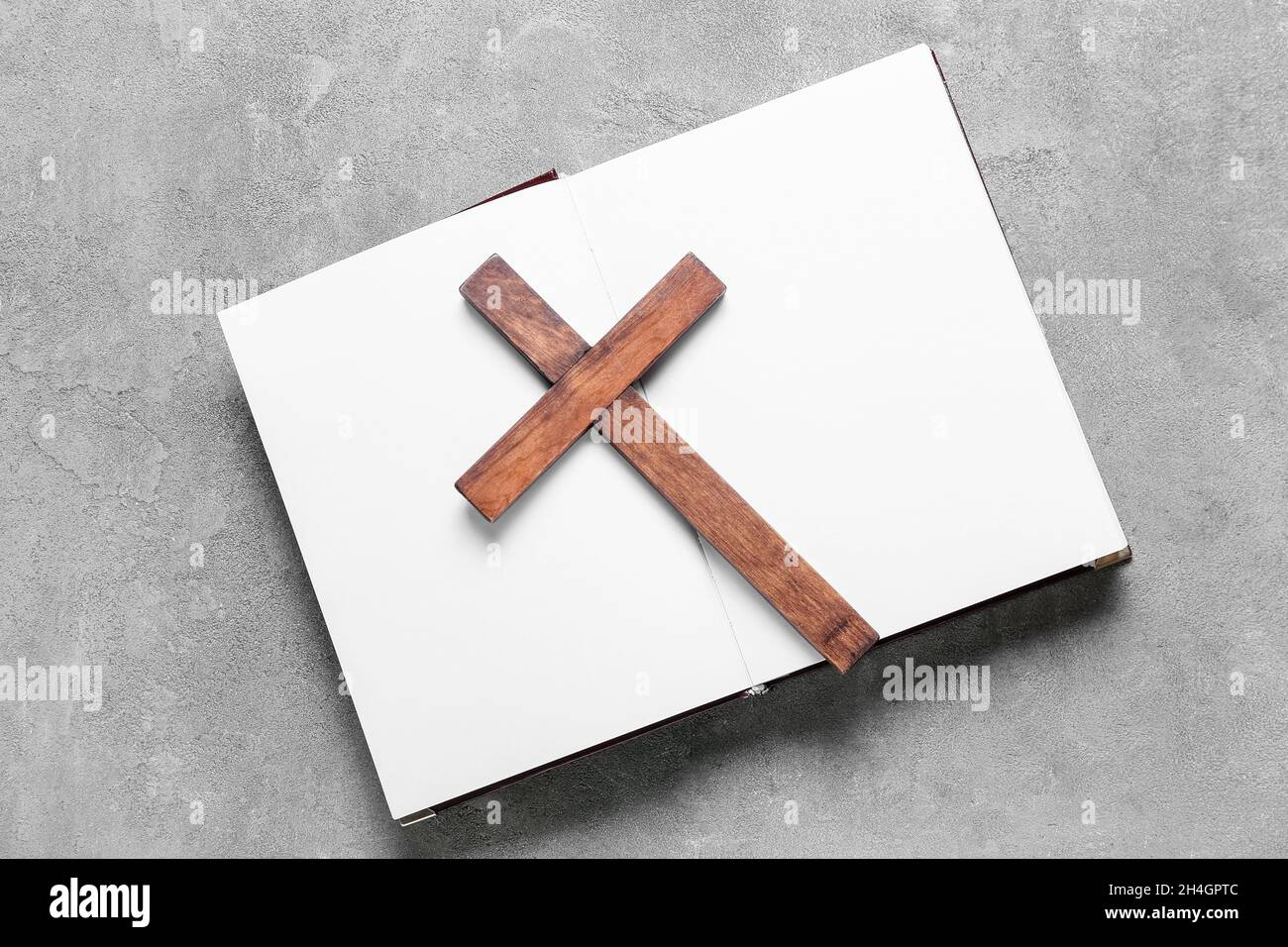 Open book with wooden cross on grunge background Stock Photo