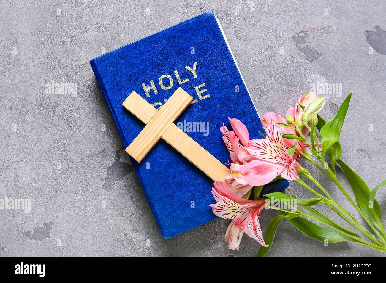 Holy Bible with cross and lily flowers on grunge background Stock Photo