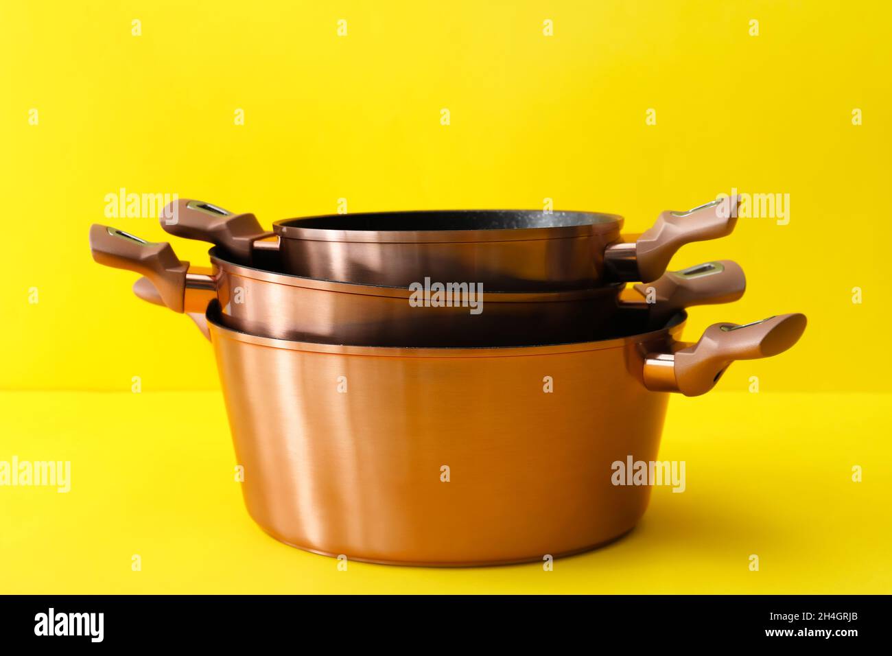 Metal cooking pots on color background Stock Photo Alamy