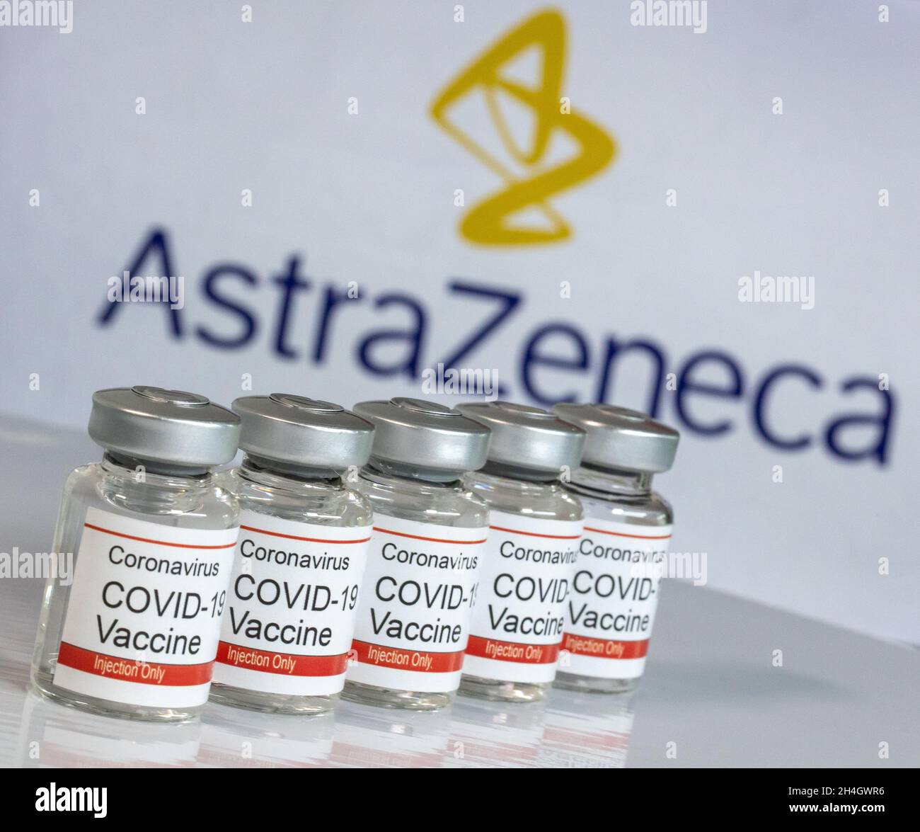 Vial of Coronavirus vaccine with Astrazeneca logo in the background Stock Photo
