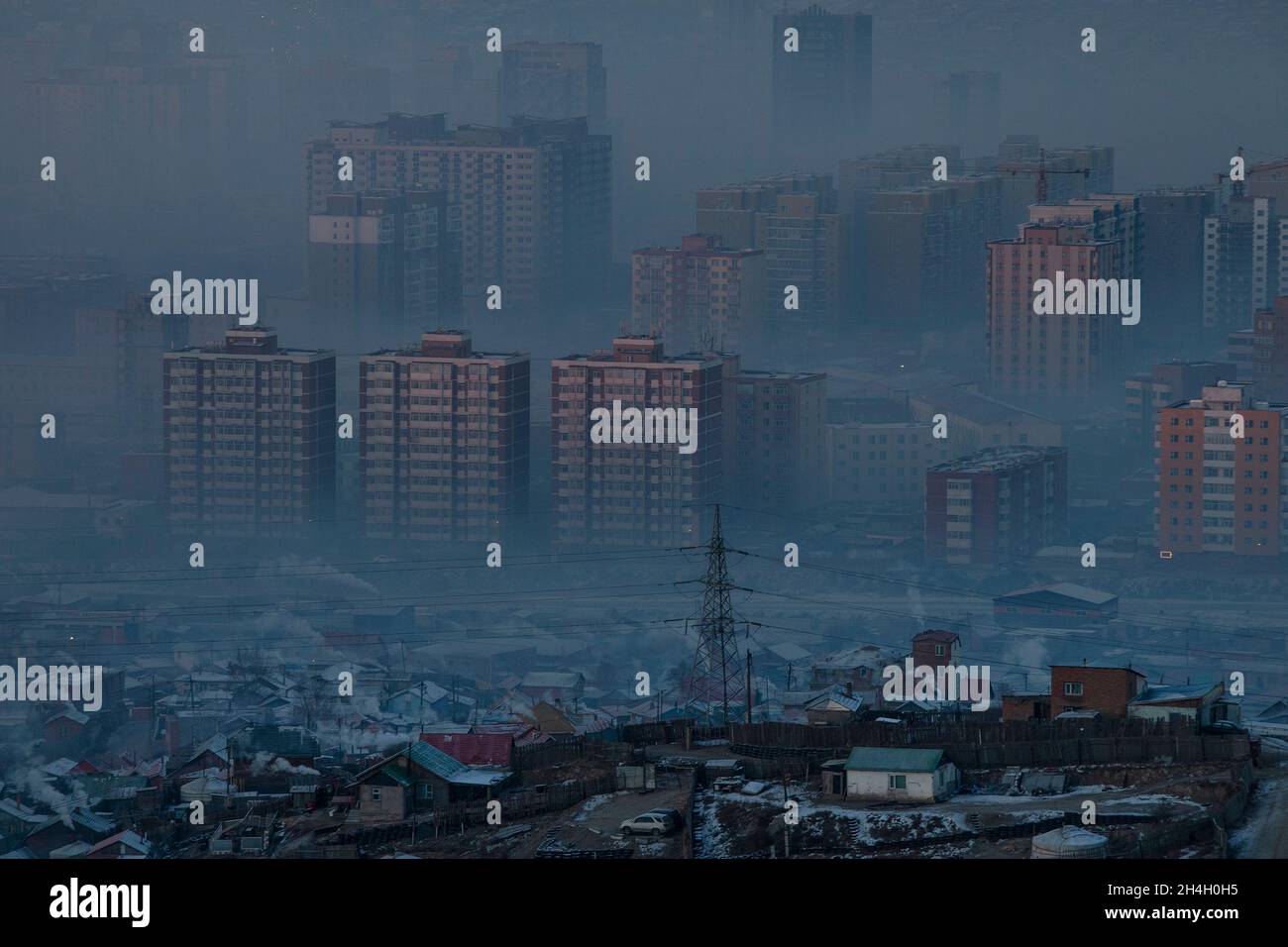 Heavy pollution engulfs the capital Ulaanbaatar in the early hours of the morning when residents are waking up and burning larger quantities of coal i Stock Photo