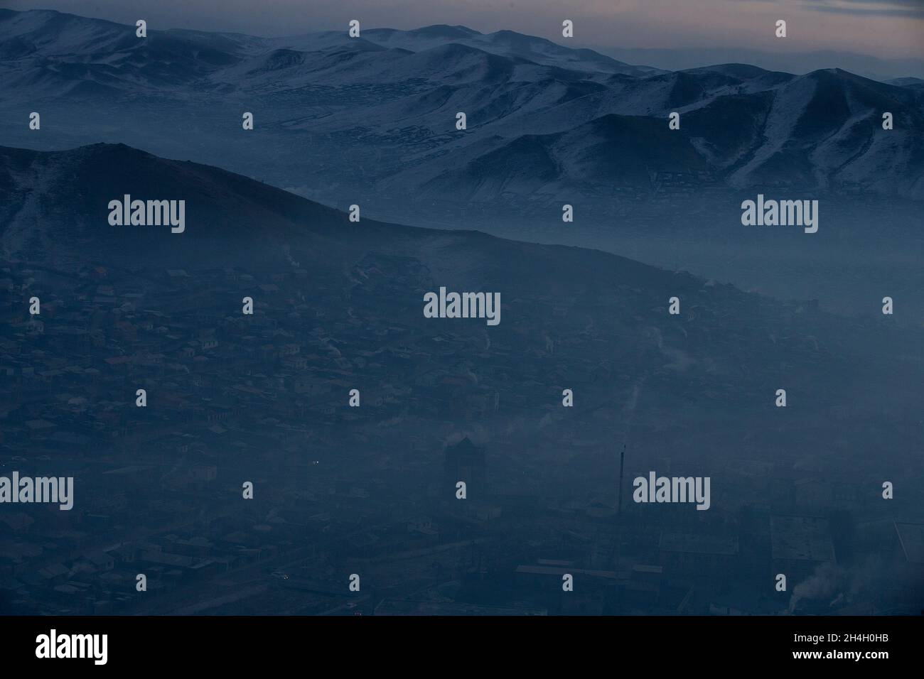 Heavy pollution engulfs the capital Ulaanbaatar in the early hours of the morning when residents are waking up and burning larger quantities of coal i Stock Photo