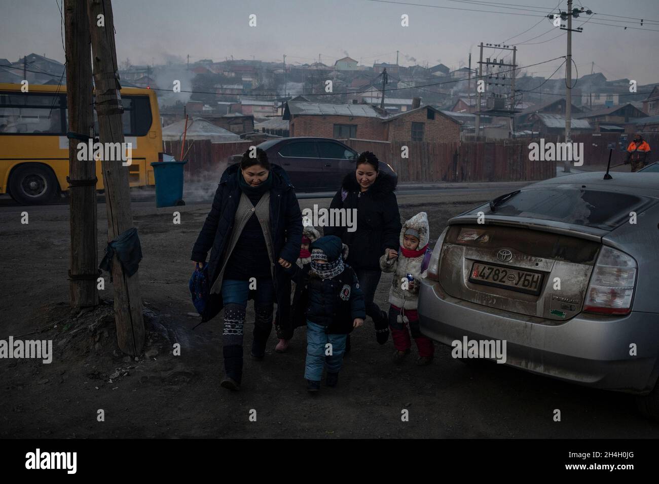 Parents bring their children to a kindergarten in one of the ger districts of the city, Ulaanbaatar, January 21, 2019. The ger districts of the city a Stock Photo