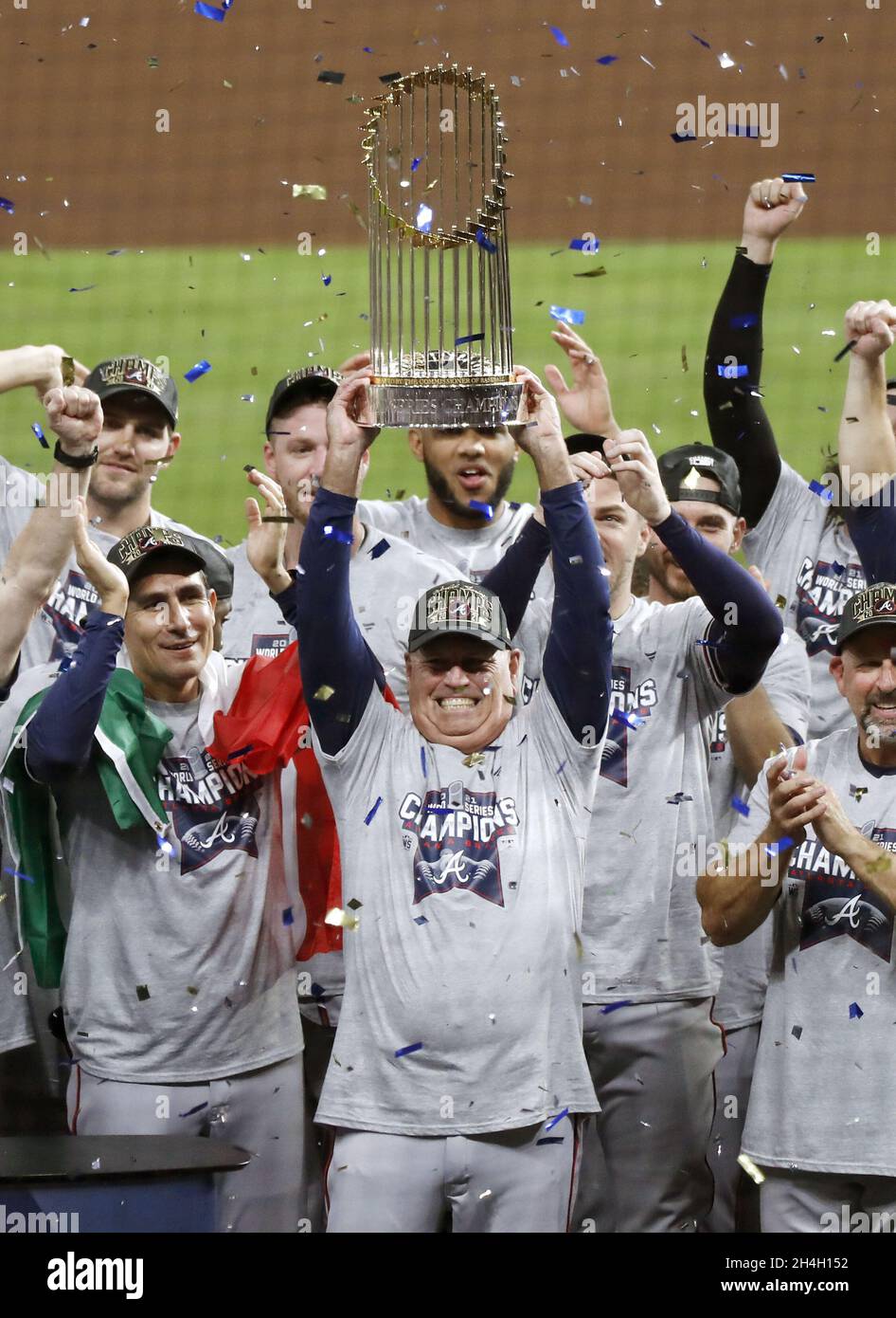 Houston, Texas. Nov. 2, 2021, Atlanta Braves manager Brian Snitker (C)  holds up the trophy after winning Game 6 of the World Series against the  Houston Astros on Nov. 2, 2021, at