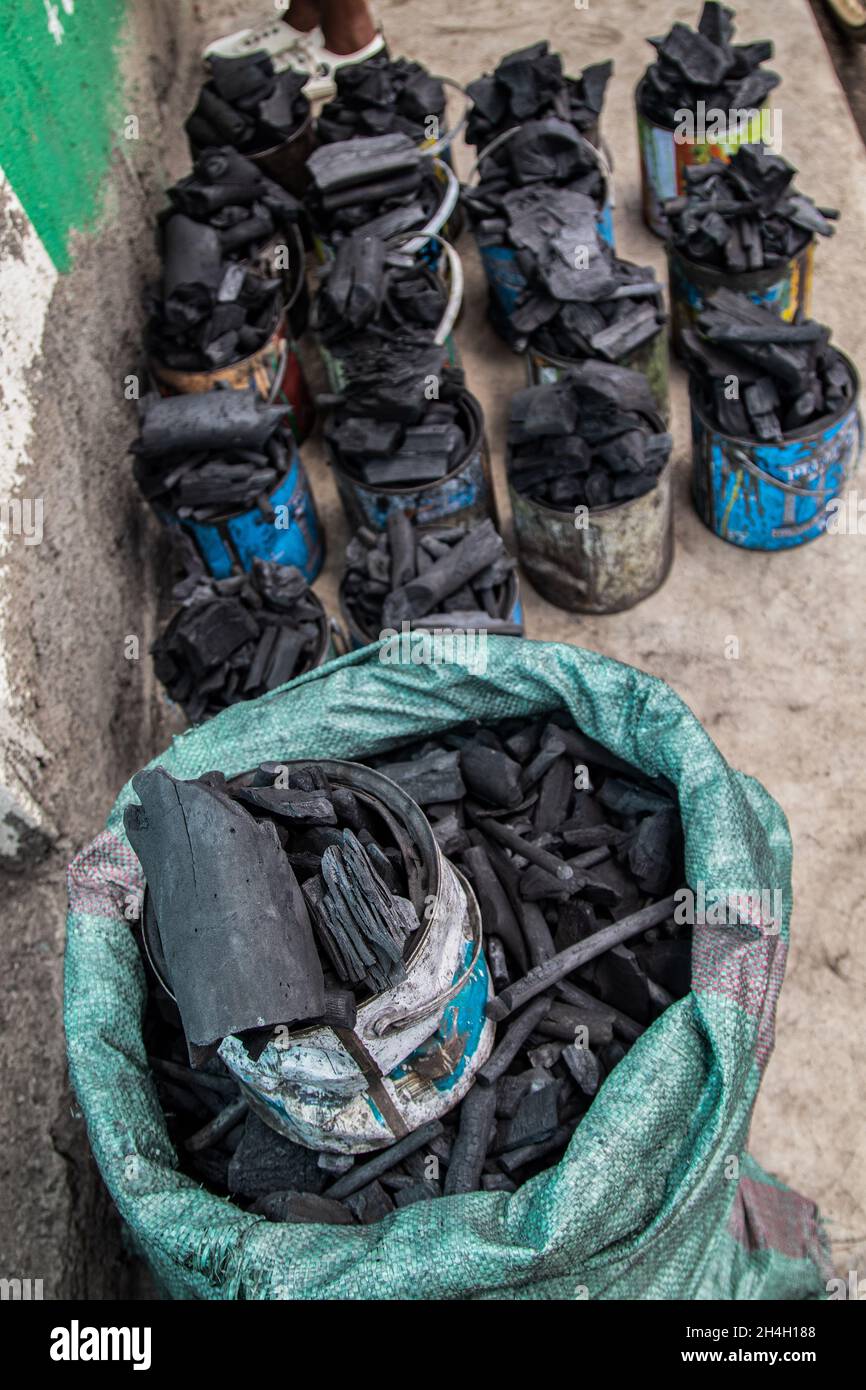 A view of charcoal packed in the tins ready for sale in Nakuru.Trees