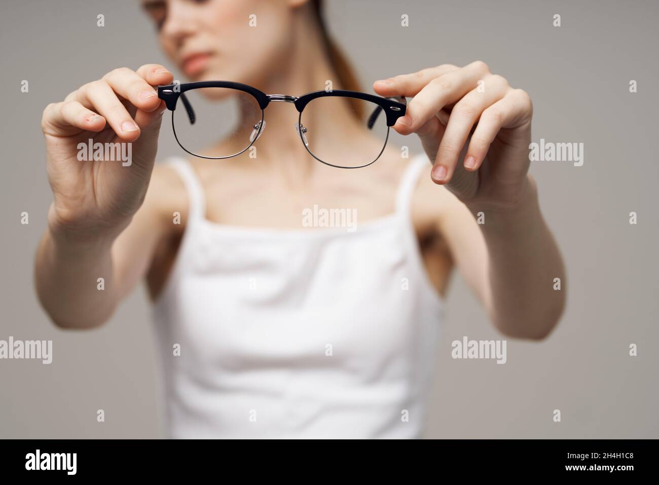 woman glasses in the hands of astigmatism studio treatment Stock Photo