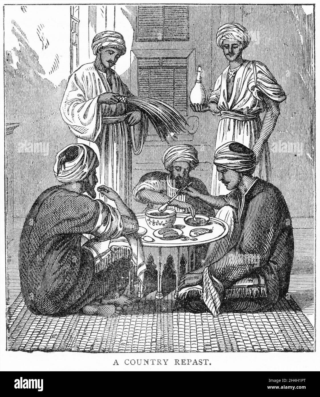 Engraving of a group of men eating in Egypt, from a publication circa 1900 Stock Photo