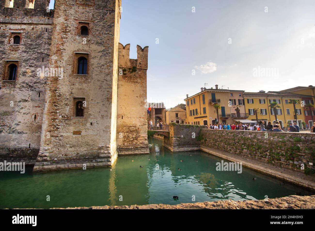 Sirmione, Italy-October 9, 2018: People relax in the town of Sirmione near the castle of Scaligera. Stock Photo
