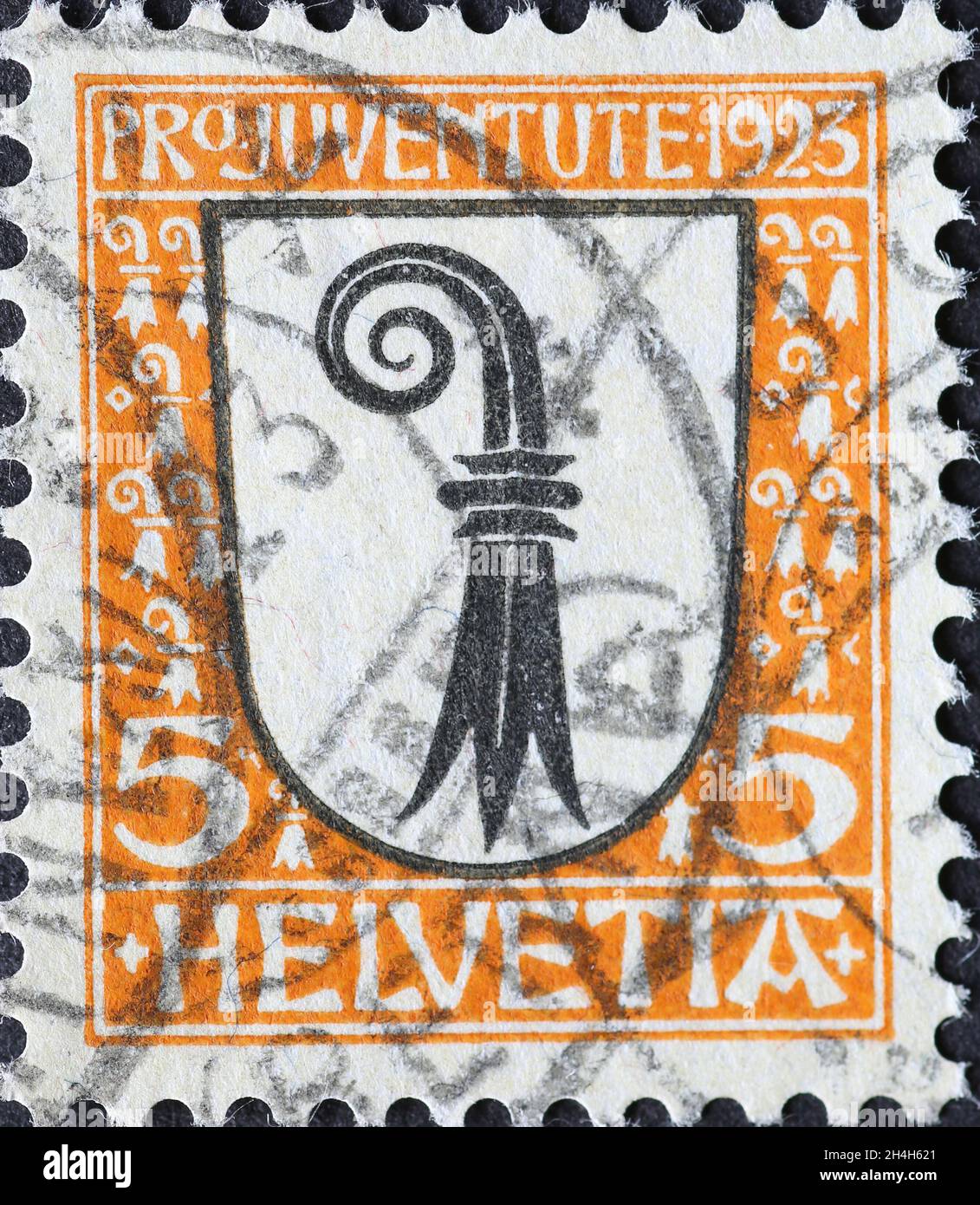 Switzerland - Circa 1923: a postage stamp printed in the Switzerland showing a white coat of arms with a stylized crook of the Swiss canton of Basel o Stock Photo