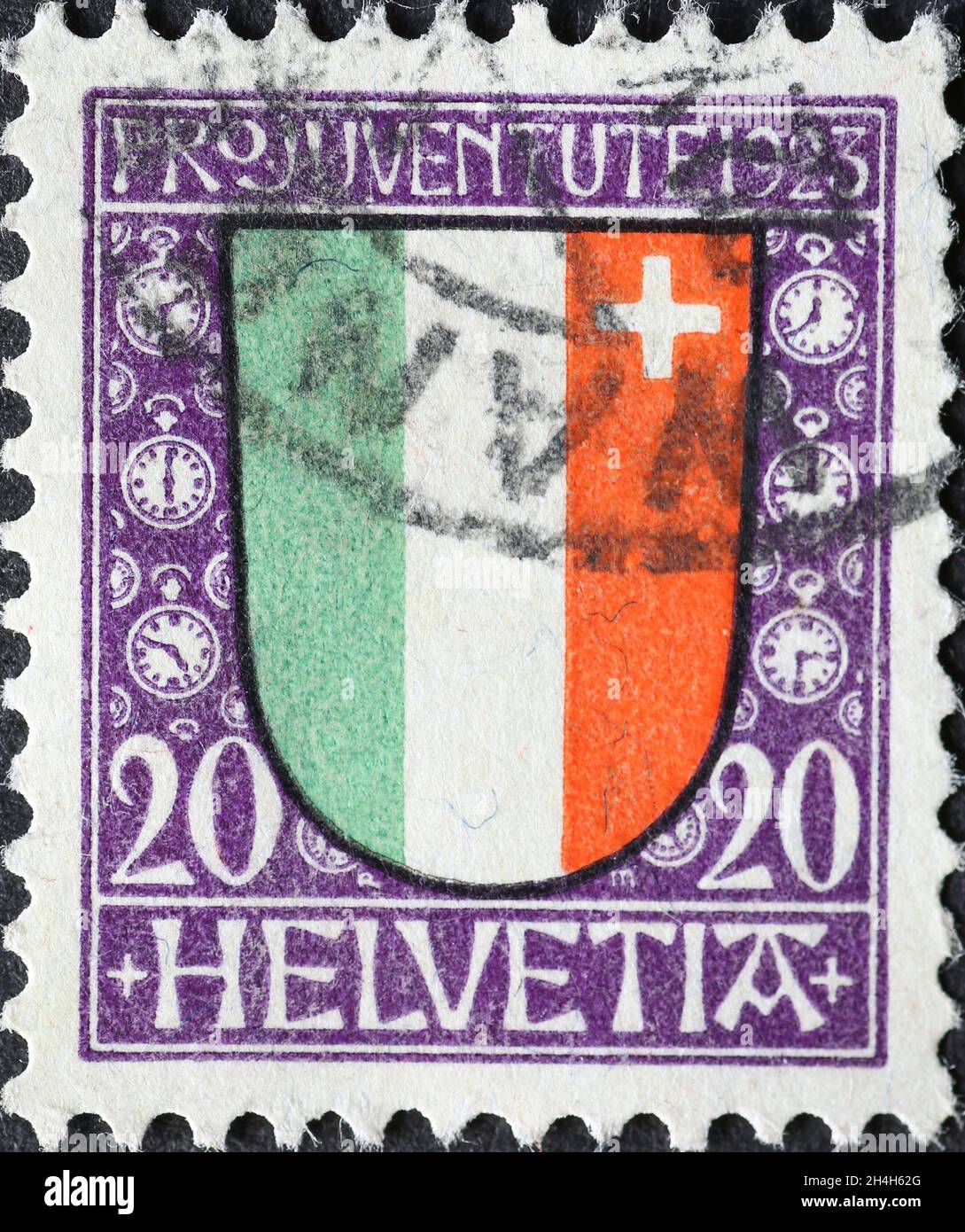 Switzerland - Circa 1923: a postage stamp printed in the Switzerland showing a green, white red coat of arms with a white cross of the Swiss canton of Stock Photo