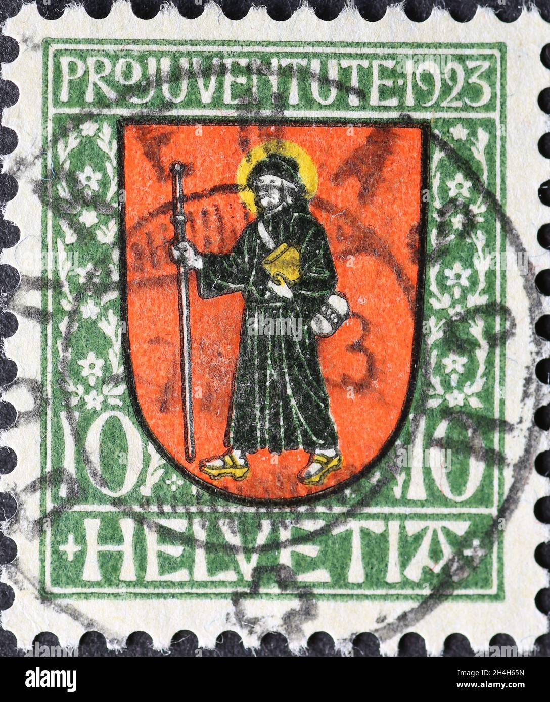Switzerland - Circa 1923: a postage stamp printed in the Switzerland showing a red coat of arms mit St. Fridolinus, an Irish missionary of the Swiss c Stock Photo