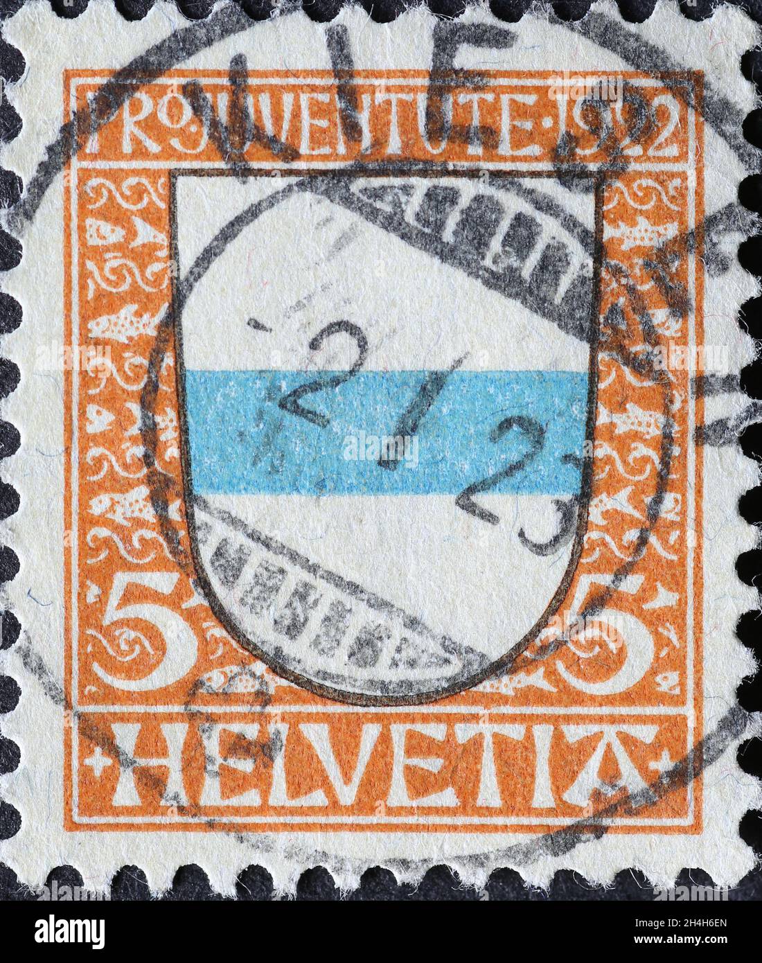 Switzerland - Circa 1922: a postage stamp printed in the Switzerland showing a blue and white coat of arms of the Swiss canton Zug on a charity postal Stock Photo