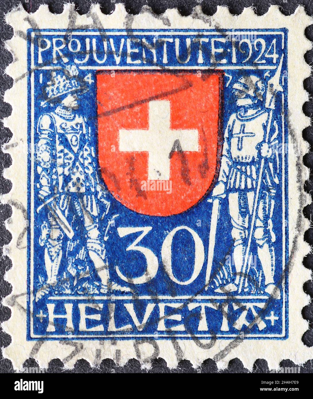 Switzerland - Circa 1924: a postage stamp printed in the Switzerland showing the federal coat of arms of Switzerland with the Burgundian Knight and a Stock Photo