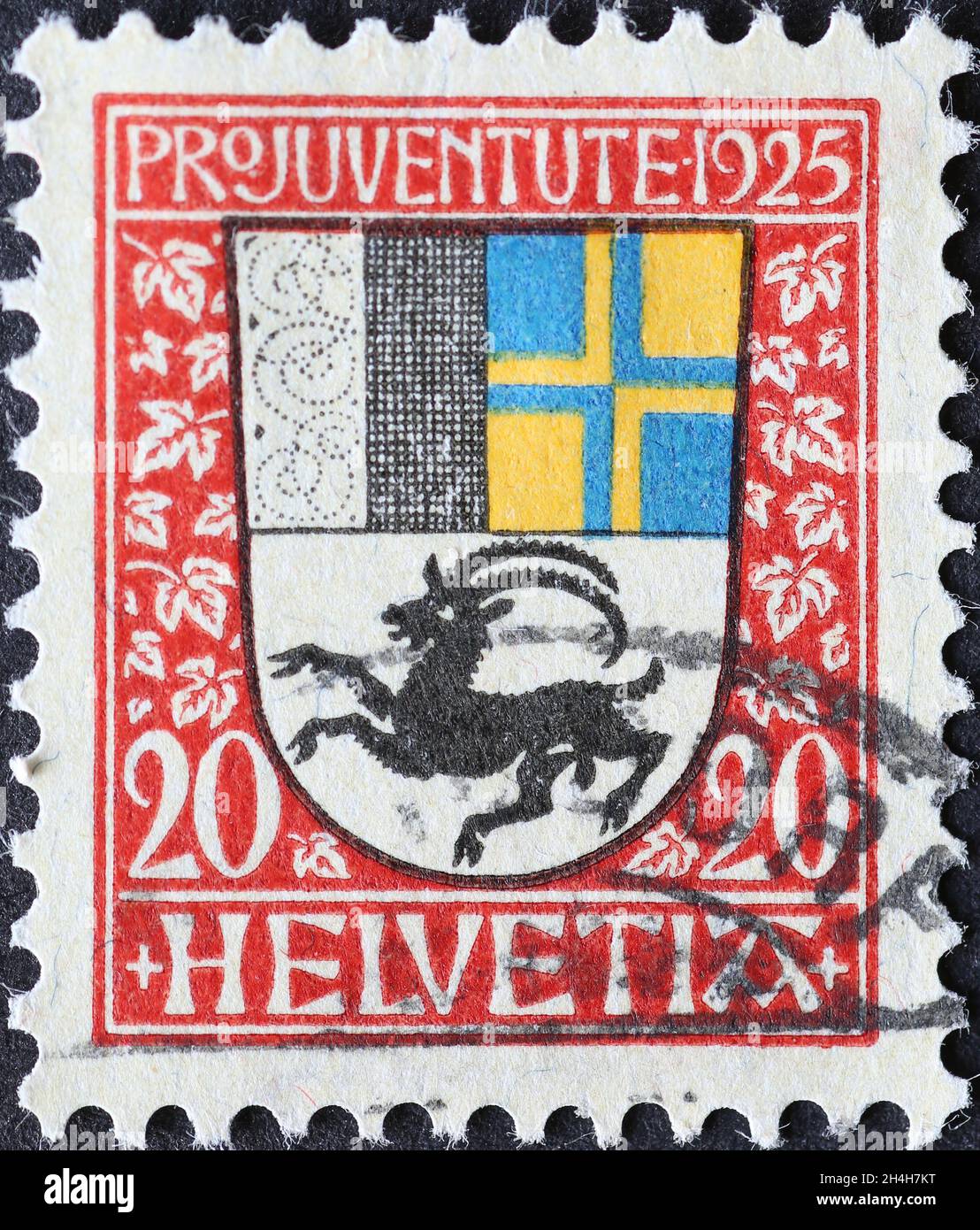 Switzerland - Circa 1925: a postage stamp printed in the Switzerland showing a coat of arms with ibex of the Swiss canton of Grisons on a charity post Stock Photo