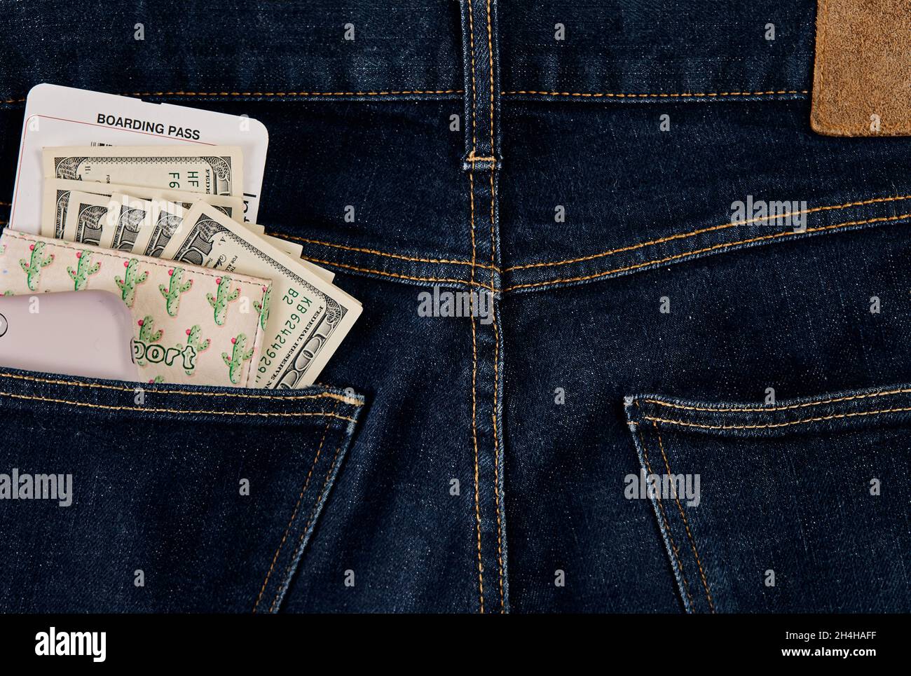 Dollars, smart and plane ticket in your pocket jeans Stock Photo Alamy