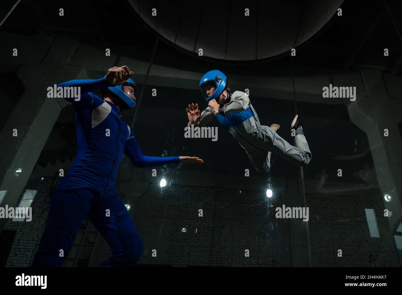A man and a woman enjoy flying together in a wind tunnel. Free fall ...