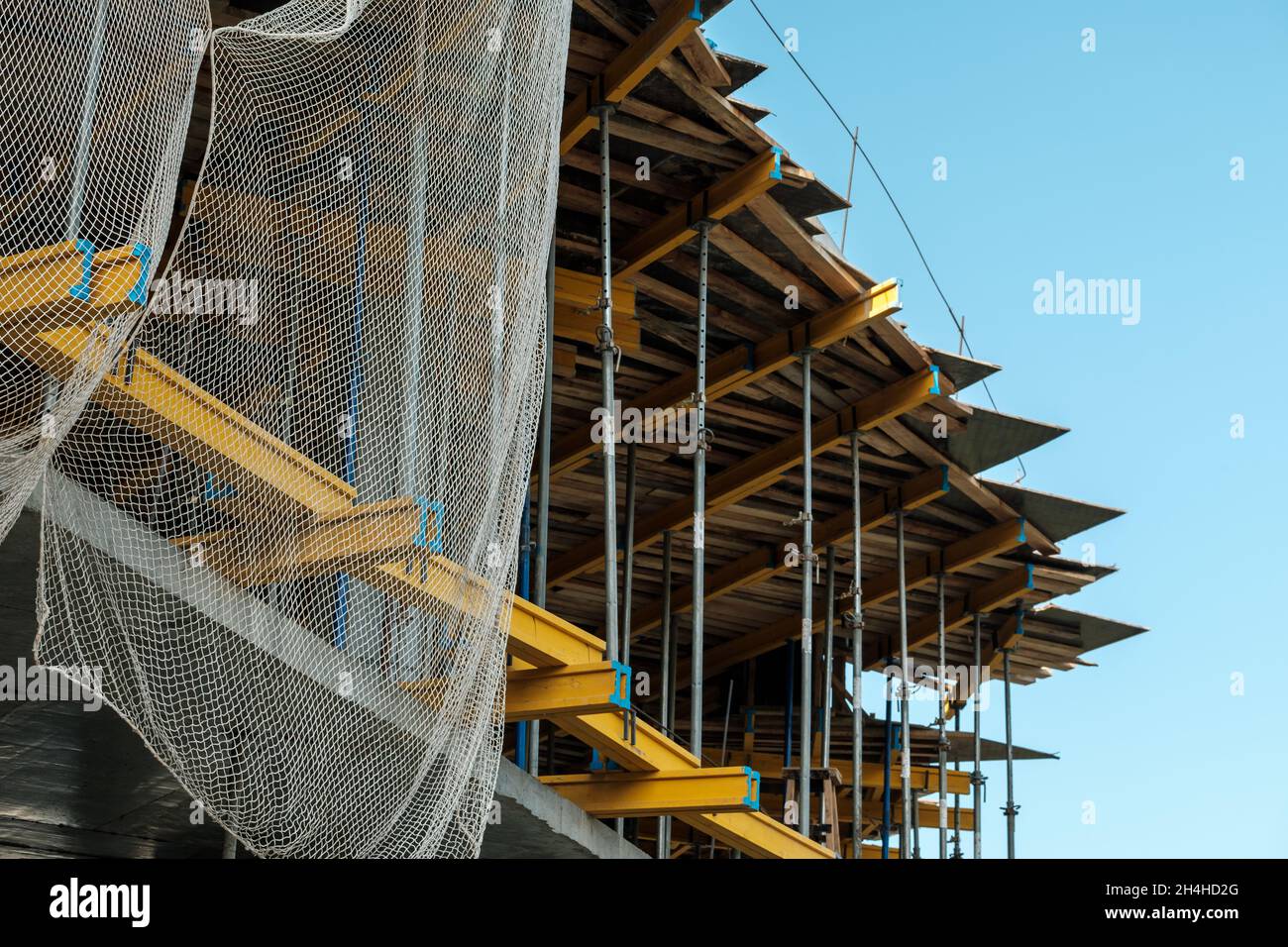 Protective building network used on building. Falsework used on skyscraper building. Stock Photo
