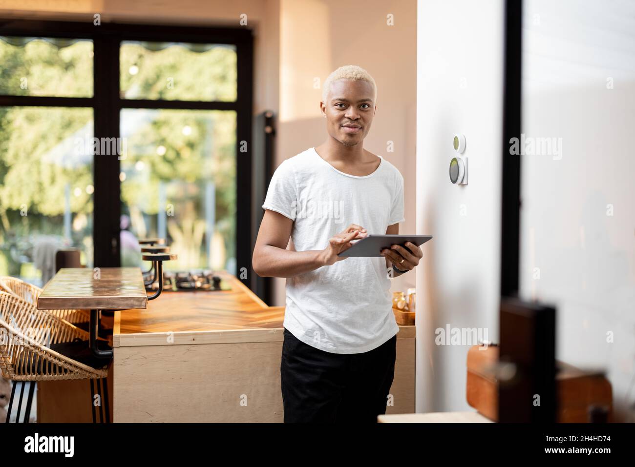 Latin man choosing temperature on thermostat Stock Photo