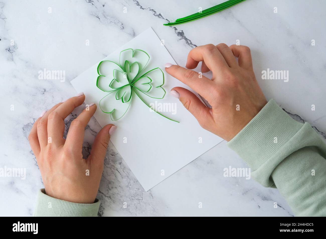 Diy St. Patricks Day greeting card made of Quilling and paper clovers on  white background. Gift idea, decor Spring, happy Patrick Day. Step by step.  T Stock Photo - Alamy