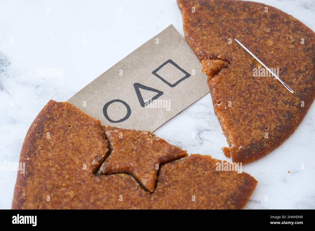 Kiev Ukraine - October 2021 squid game invitation card Star shape Homemade  sugar candy. Playing Korean Dalgona or Ppopgi honeycomb candy from Squid Ga  Stock Photo - Alamy