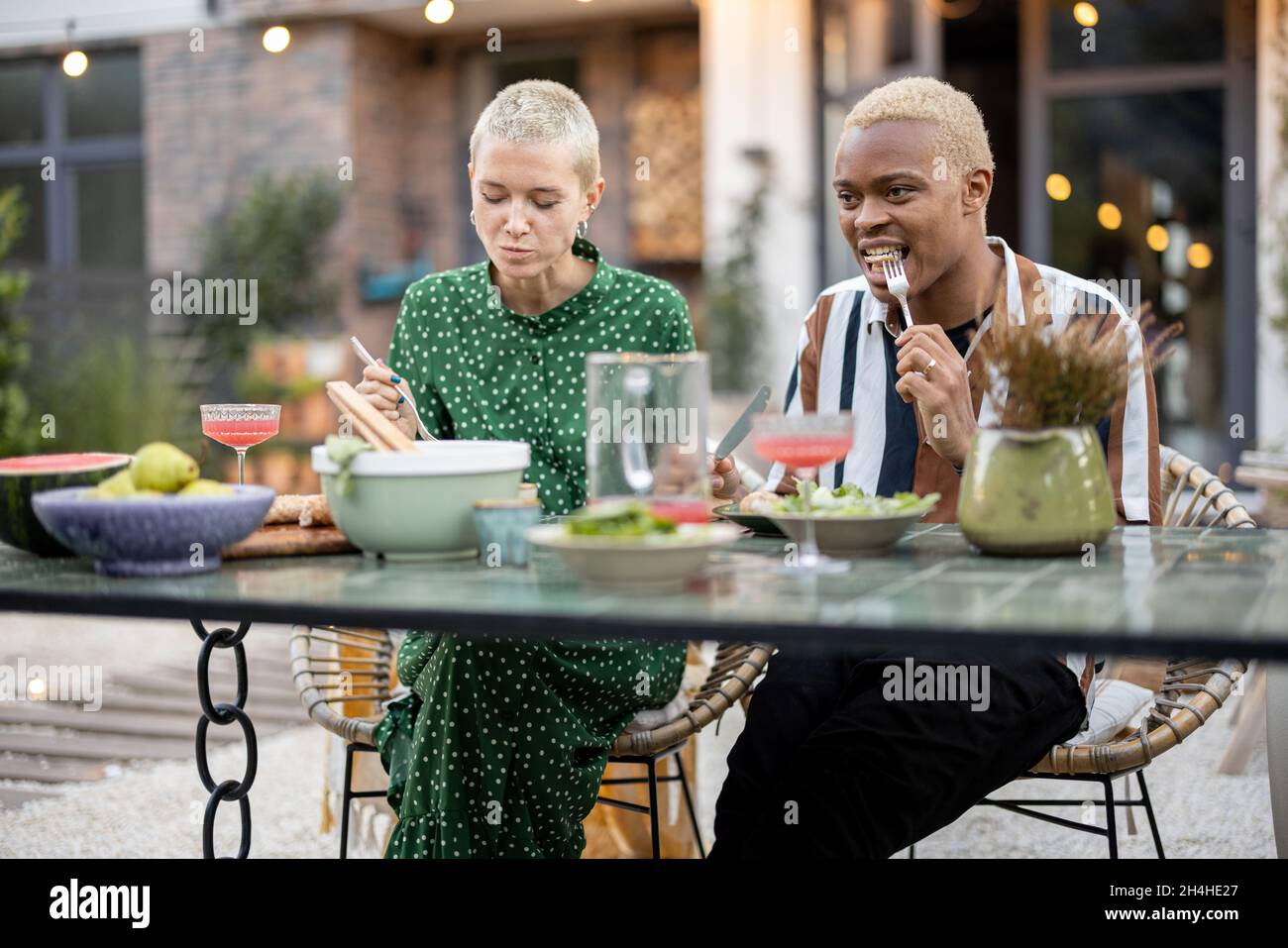 Multiracial couple having dinner at their backyard Stock Photo