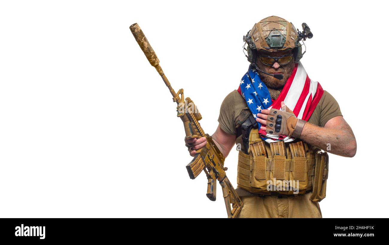 An American soldier stands against white background with a flag on his shoulders. Concept of the day of remembrance of veterans. Veterans day. Stock Photo