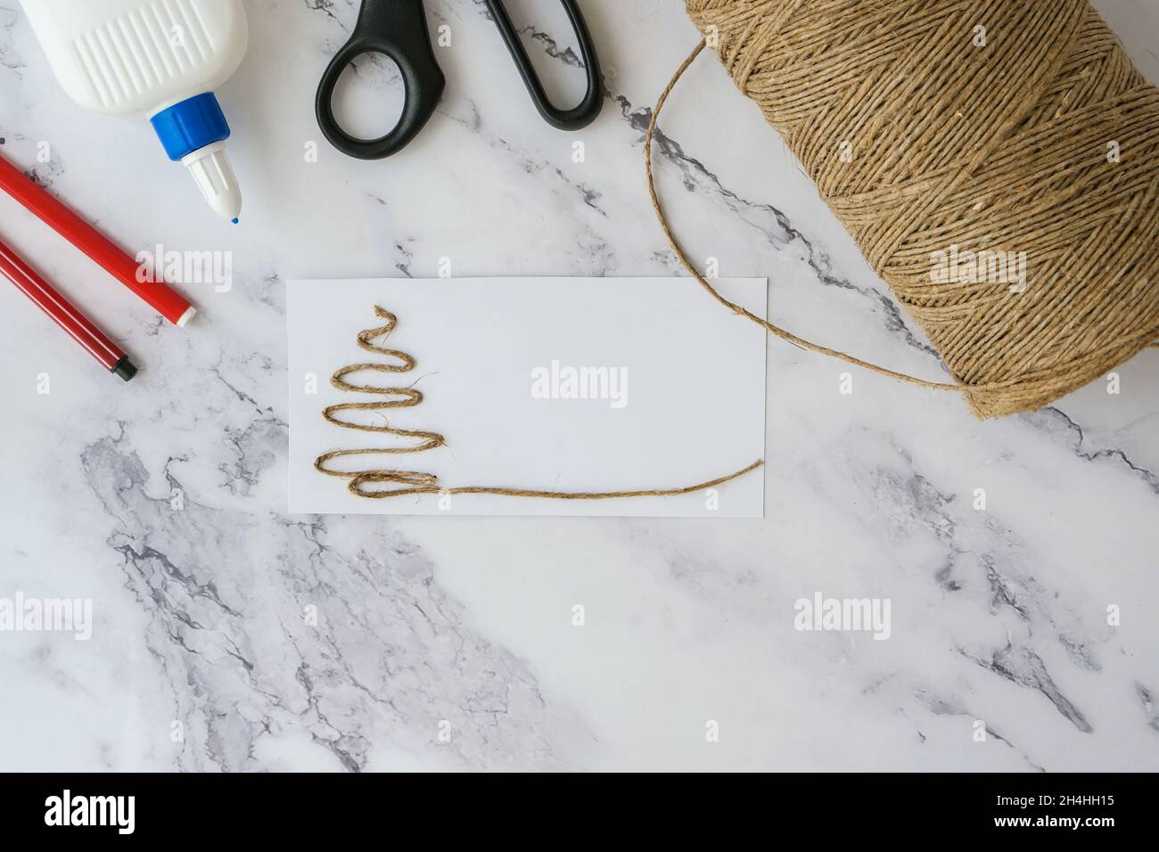 Christmas tree made of rope. Top view of hands making step by step DIY ...