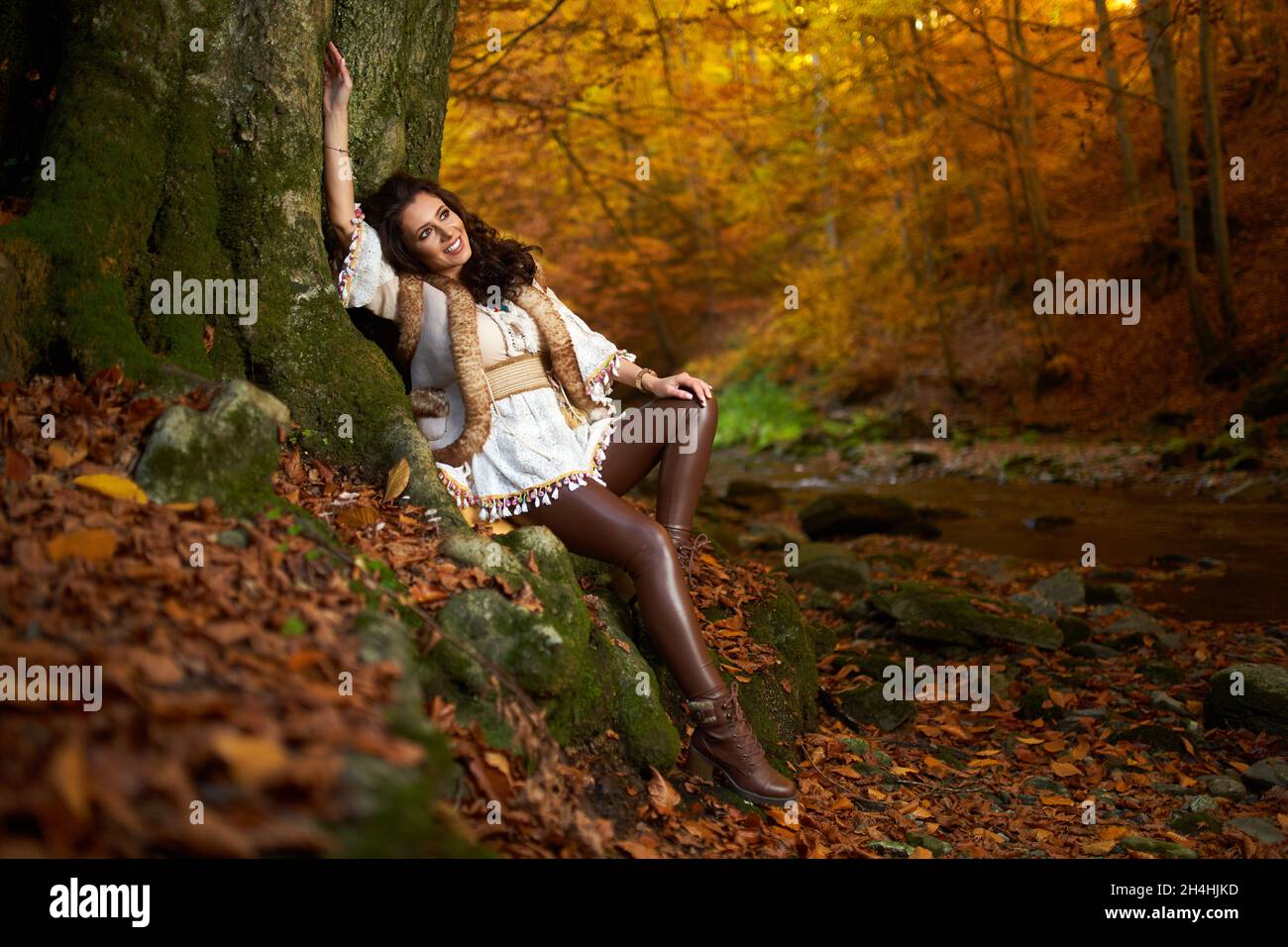 Portrait of a beautiful young woman by the river mid autumn Stock Photo ...