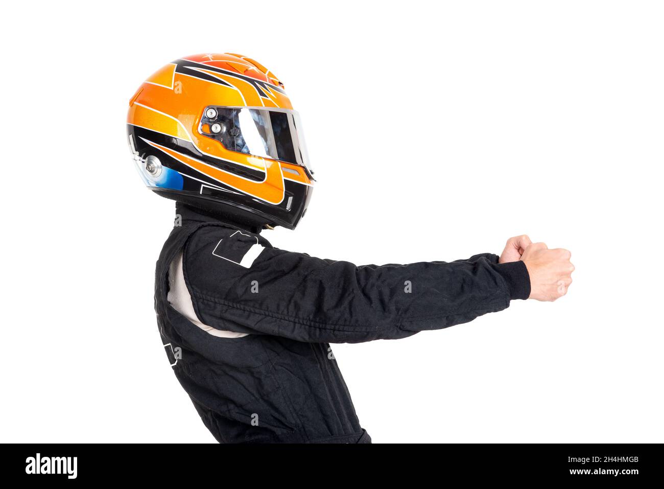 Racing driver posing with helmet isolated in white Stock Photo