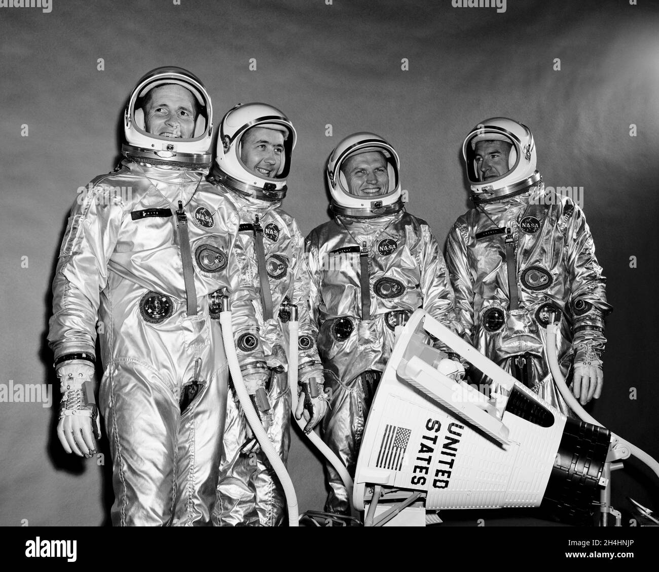 (10 Sept. 1964) --- View of the Gemini-4 prime crew and backup crew in pressure suits. They are standing around a model of the Gemini spacecraft. From left to right are astronauts Edward H. White II, pilot; James A. McDivitt, command pilot; Frank Borman and James A. Lovell Jr., backup crew Stock Photo