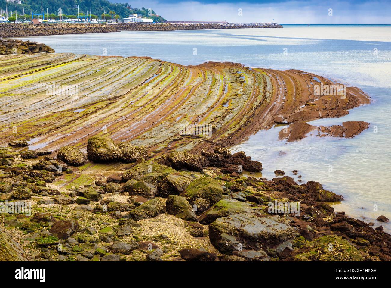 Spectacular rocks uncovers the low tide in the cove of the Bidasoa river in Hondarribia, Euskadi, Spain Stock Photo