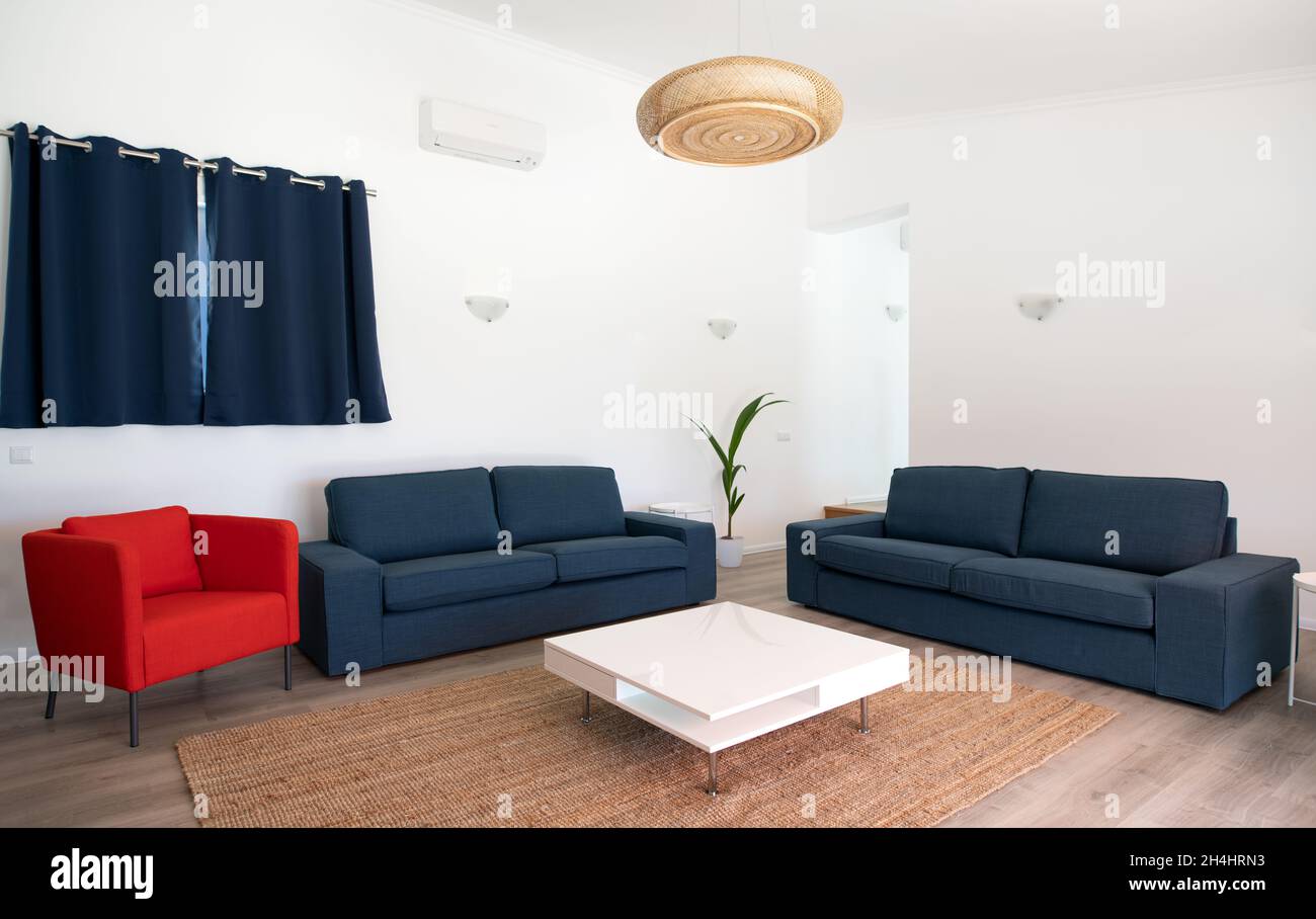 Modern living room with white walls and blue sofas Stock Photo